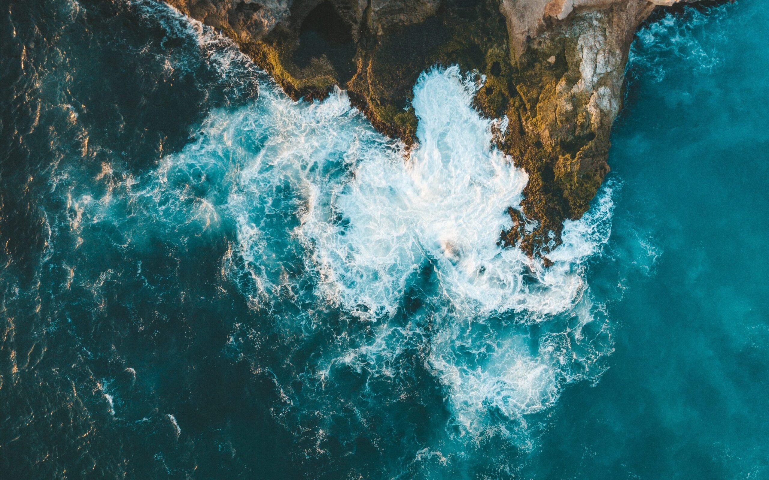 vertical aerial shot sea waves hitting cliff edited scaled